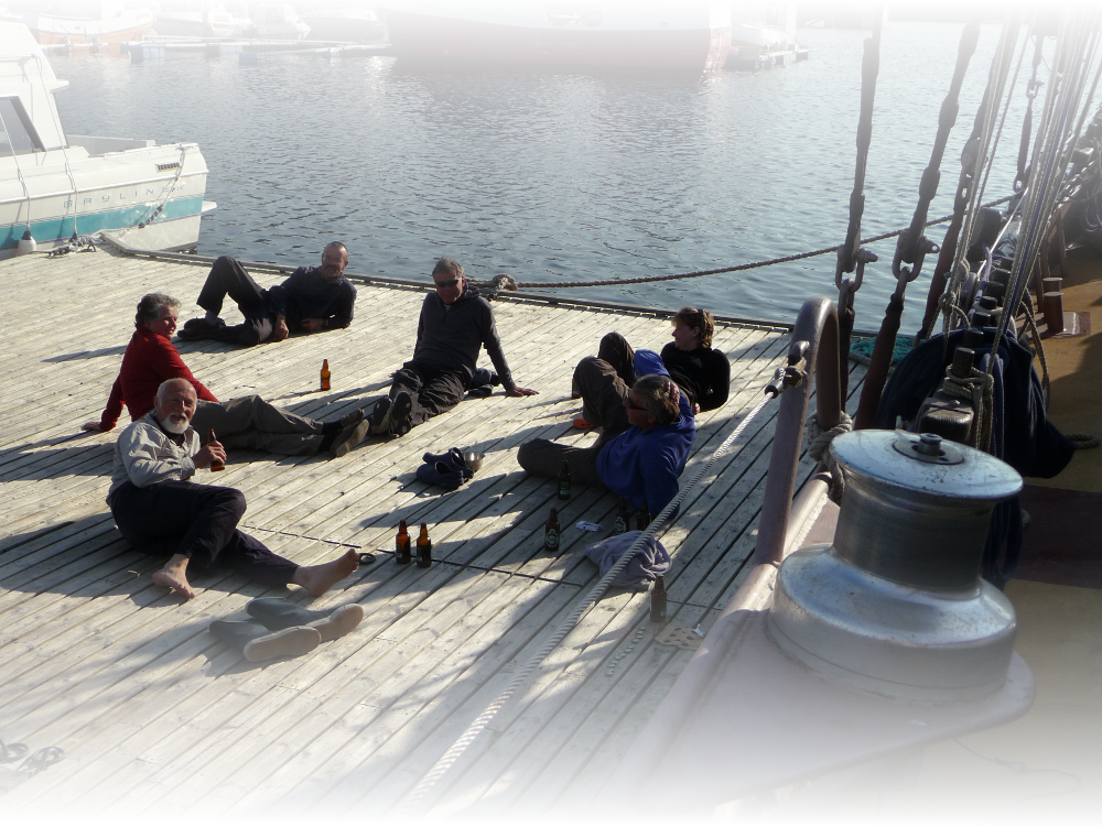 The crew of the schooner Trinovante stop for a beer after a hard days sailing.
