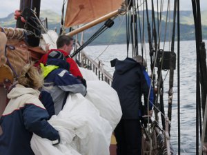 Michael and the rest of the crew getting the big fishaker sail down. Michael and the rest of the crew getting the big fishaker sail down.